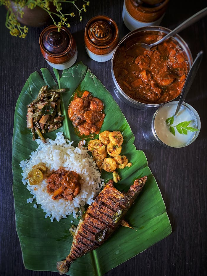 Delicious South Indian meal served on banana leaf with rice and fish curry.